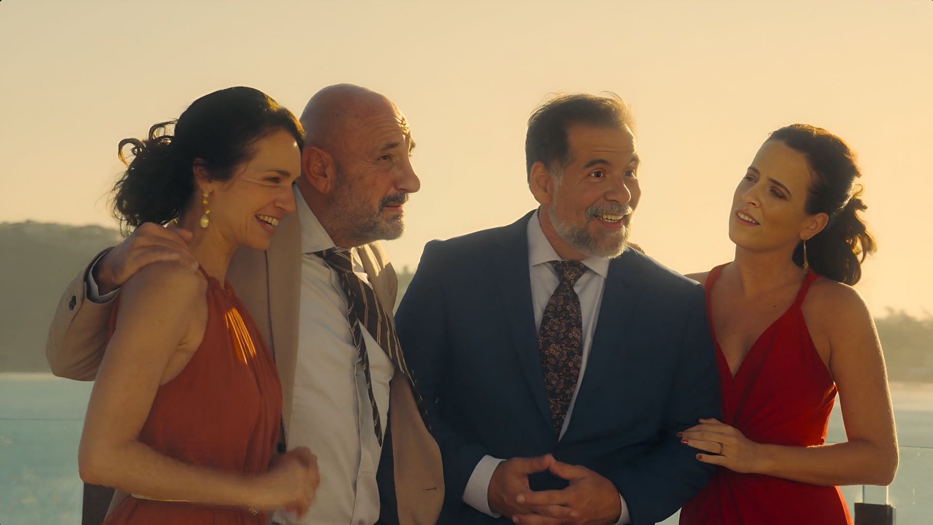 The two families smile together in Almost Family, showing how far they’ve come from rivalry to unity. (Image via Netflix)